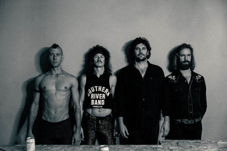 Black and white portrait of Australian rock group The Southern River Band standing against a plain wall.